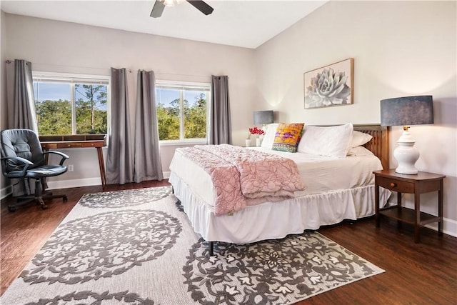 bedroom featuring ceiling fan, dark wood-style flooring, and baseboards