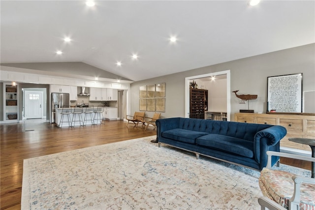 living room with vaulted ceiling and dark hardwood / wood-style floors