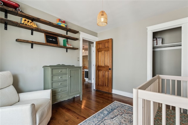 bedroom featuring dark wood-type flooring and a closet