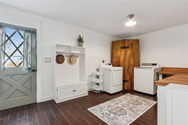 washroom with cabinets, separate washer and dryer, and dark hardwood / wood-style floors