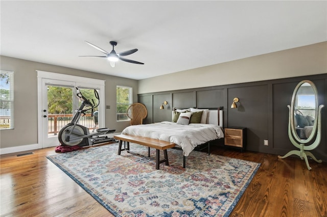 bedroom featuring access to outside, dark hardwood / wood-style floors, and ceiling fan