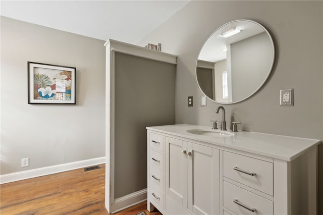 bathroom with hardwood / wood-style flooring and vanity