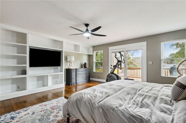 bedroom featuring multiple windows, hardwood / wood-style flooring, access to outside, and ceiling fan