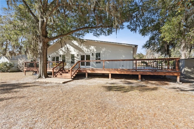 rear view of house featuring a wooden deck