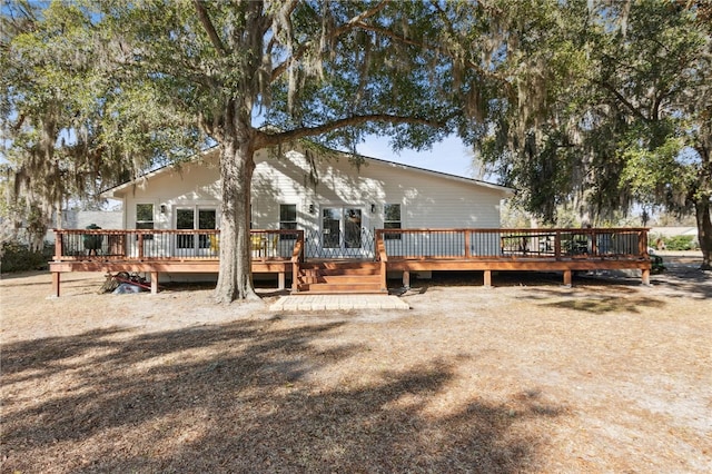 rear view of property with a wooden deck