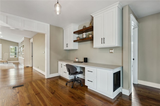 office featuring dark wood-type flooring and built in desk