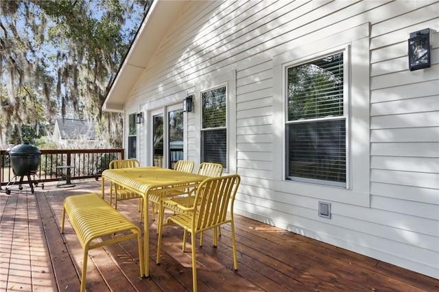 wooden deck featuring a grill