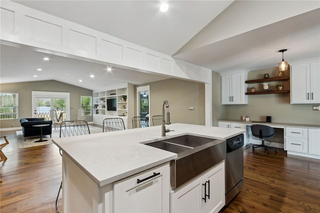 kitchen featuring stainless steel dishwasher, sink, a kitchen island with sink, and white cabinets