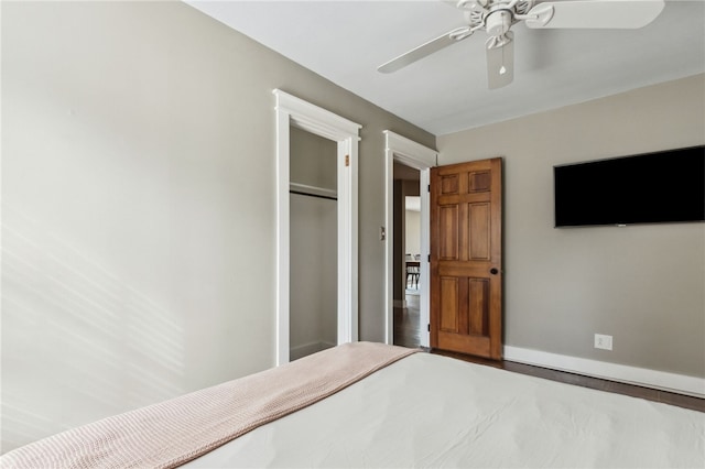 unfurnished bedroom featuring ceiling fan, wood-type flooring, and a closet