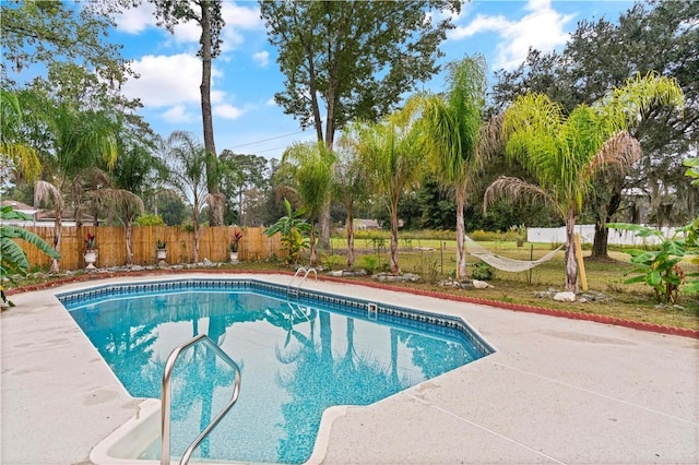 view of swimming pool with a fenced in pool, a patio, a yard, and a fenced backyard