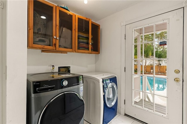 washroom with cabinet space, independent washer and dryer, and marble finish floor