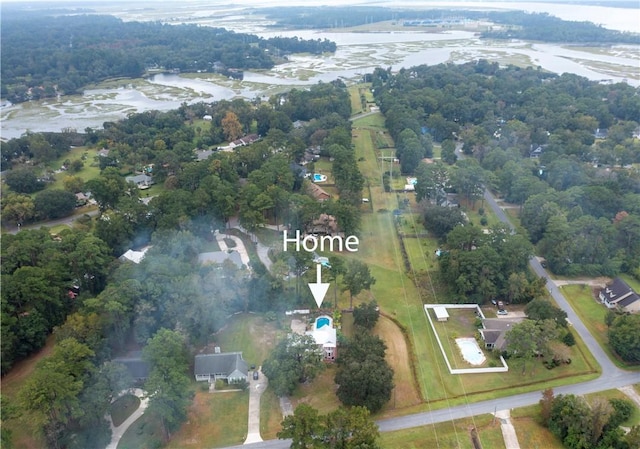 bird's eye view with a forest view and a water view