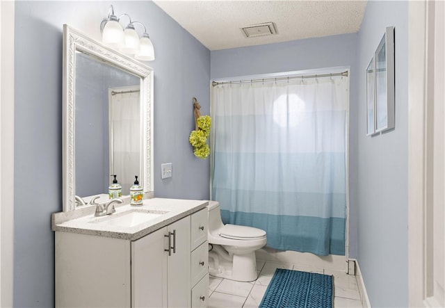 bathroom with tile patterned flooring, visible vents, toilet, vanity, and a textured ceiling