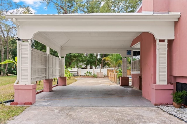 exterior space featuring an attached carport and driveway