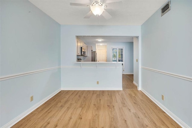 unfurnished room featuring ceiling fan and light hardwood / wood-style floors