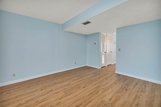 spare room with light wood-type flooring