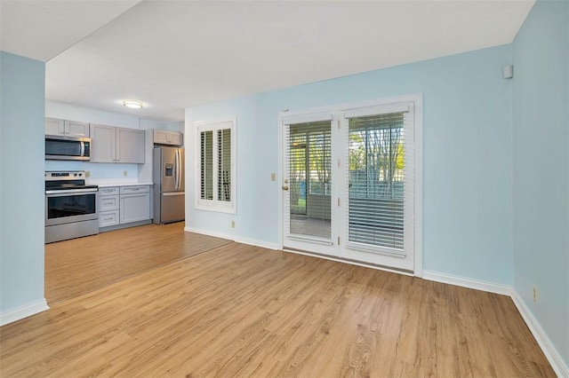 unfurnished living room featuring light wood-type flooring