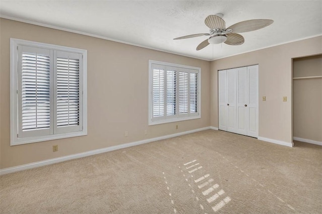 unfurnished bedroom featuring ceiling fan and light carpet