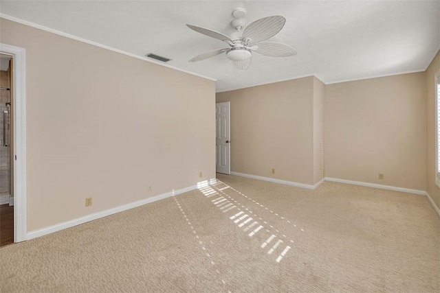 empty room featuring carpet flooring, ceiling fan, and ornamental molding