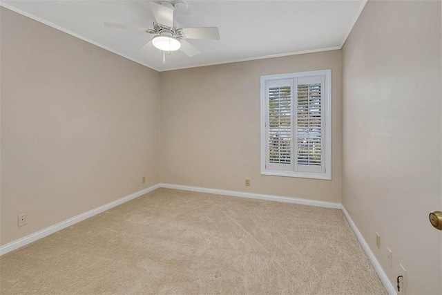 carpeted spare room featuring crown molding and ceiling fan