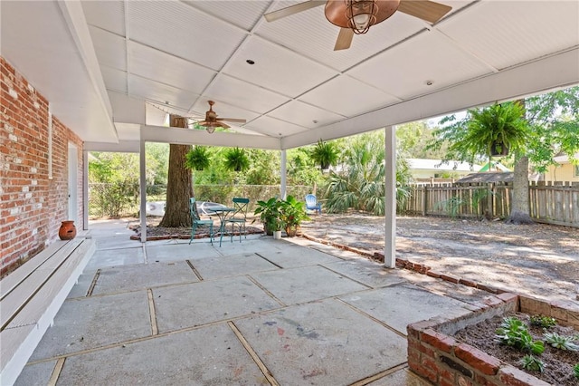 view of patio featuring outdoor dining area, a ceiling fan, and a fenced backyard