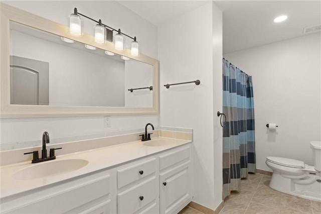 full bath featuring a sink, recessed lighting, toilet, and double vanity