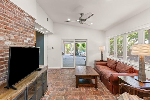 living room featuring ceiling fan, visible vents, vaulted ceiling, brick floor, and recessed lighting
