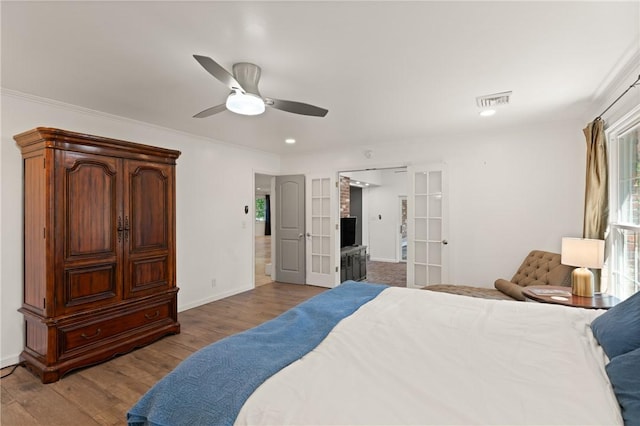 bedroom featuring ceiling fan, french doors, baseboards, wood finished floors, and visible vents