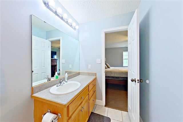 20 Marla St, Hoboken, GA 31542 - ensuite bathroom with vanity, tile patterned floors, and a textured ceiling