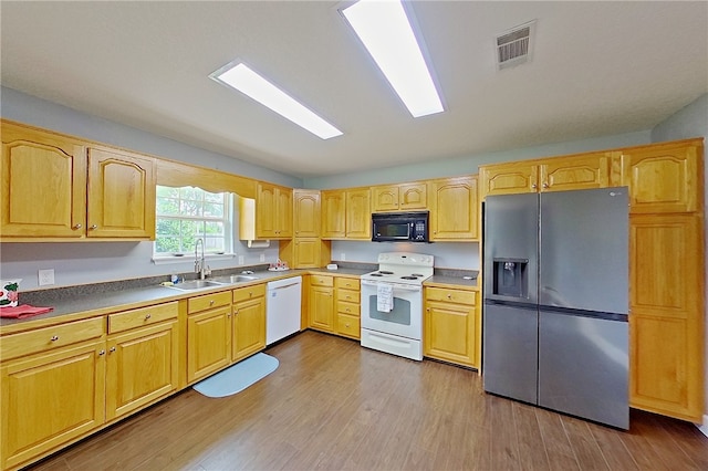 20 Marla St, Hoboken, GA 31542 - kitchen with white appliances, a sink, wood finished floors, and light brown cabinets