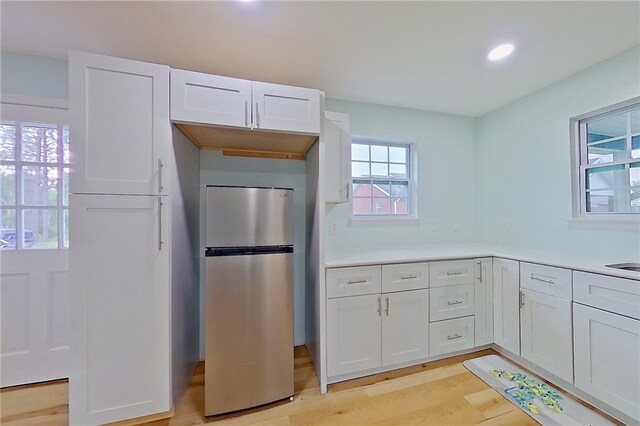 20 Marla St, Hoboken, GA 31542 - kitchen with freestanding refrigerator, light wood finished floors, white cabinets, recessed lighting, and light countertops