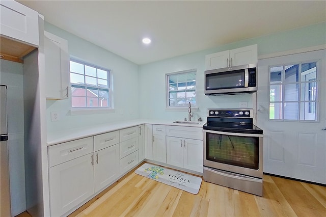 20 Marla St, Hoboken, GA 31542 - kitchen with stainless steel appliances, a sink, healthy amount of natural light, white cabinets, and recessed lighting