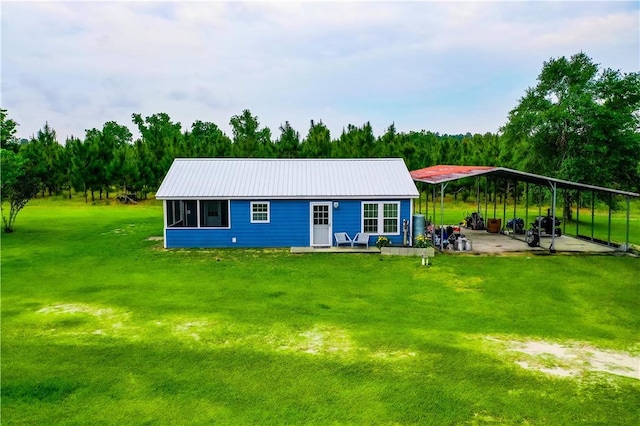 20 Marla St, Hoboken, GA 31542 - view of front of home with a detached carport, a front yard, and metal roof