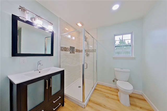 20 Marla St, Hoboken, GA 31542 - full bathroom with wood finished floors, toilet, a shower stall, vanity, and baseboards