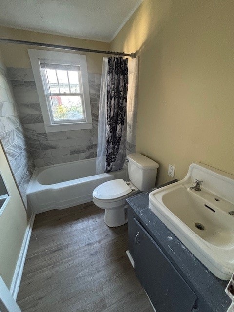 full bathroom featuring vanity, shower / bath combo, hardwood / wood-style flooring, toilet, and a textured ceiling