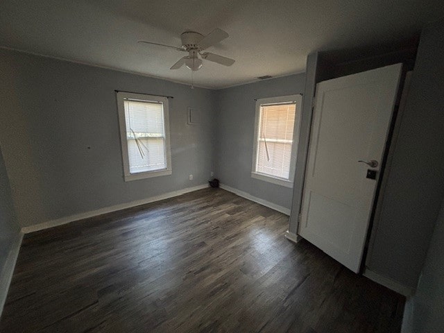 unfurnished room featuring ceiling fan and dark hardwood / wood-style flooring