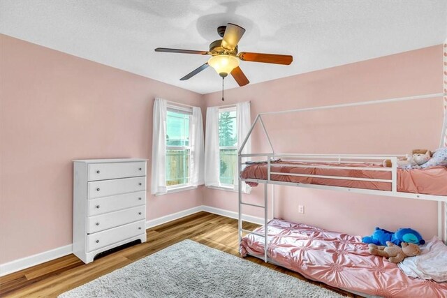 bedroom featuring hardwood / wood-style floors and ceiling fan