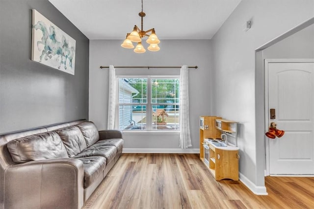 living room featuring a chandelier and light hardwood / wood-style floors