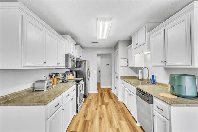 kitchen featuring appliances with stainless steel finishes and white cabinetry