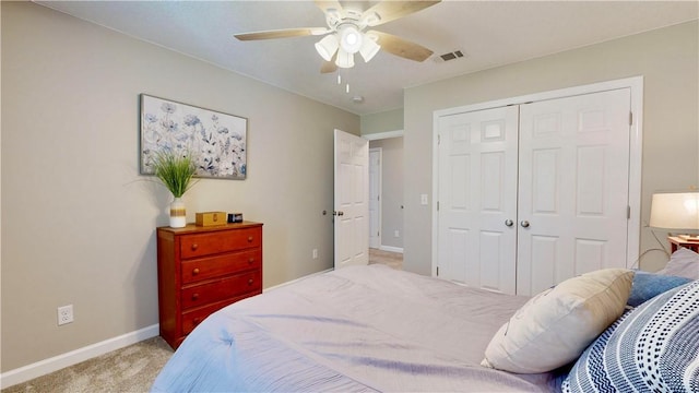 carpeted bedroom with ceiling fan and a closet