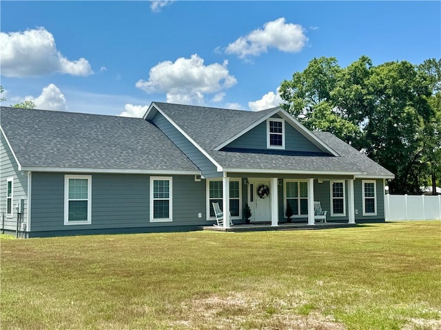view of front of home with a porch and a front yard