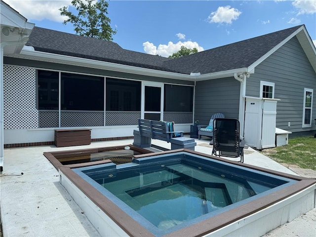rear view of property featuring a sunroom, an outdoor living space, a patio area, and an outdoor hot tub