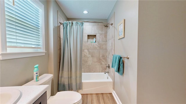 full bathroom featuring shower / tub combo, vanity, hardwood / wood-style flooring, and toilet