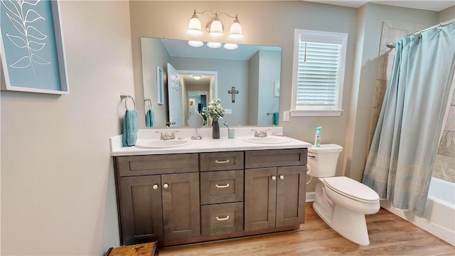 full bathroom featuring shower / bath combo with shower curtain, vanity, wood-type flooring, and toilet