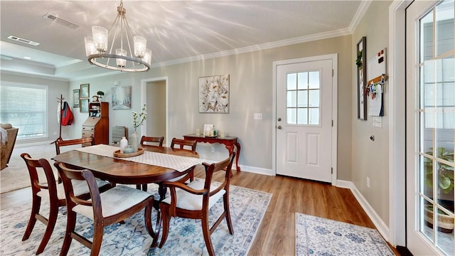 dining area with a wealth of natural light, a chandelier, and light wood-type flooring