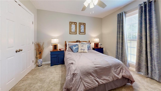 carpeted bedroom with multiple windows and ceiling fan