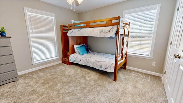 bedroom featuring ceiling fan and light carpet