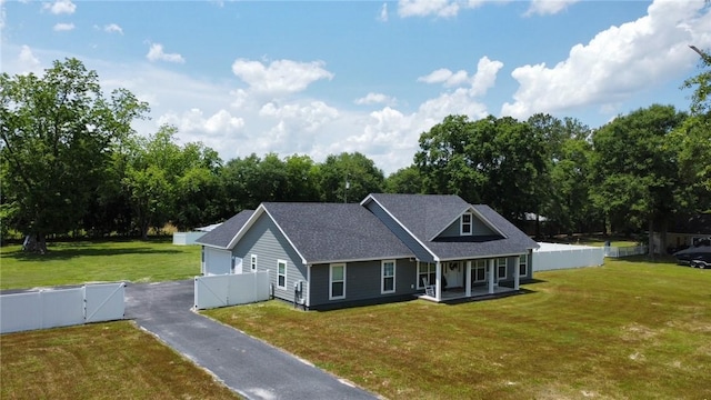 view of front of house with a porch and a front lawn