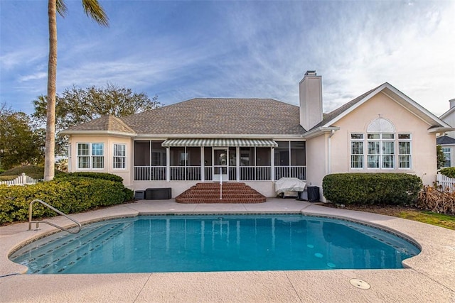 view of pool with a sunroom and a patio area