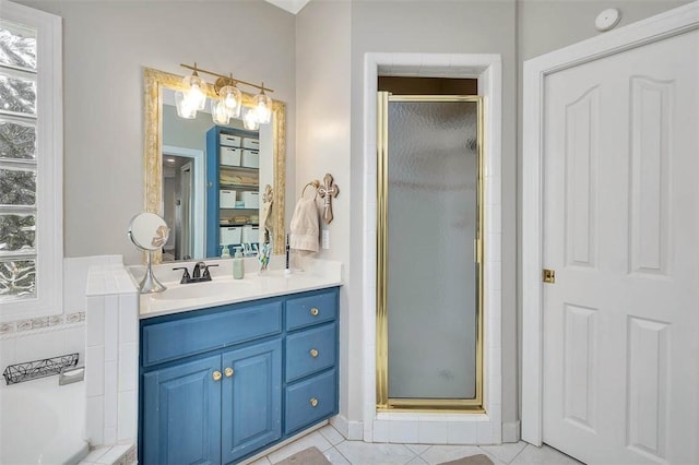 bathroom with vanity, a shower with shower door, and tile patterned flooring